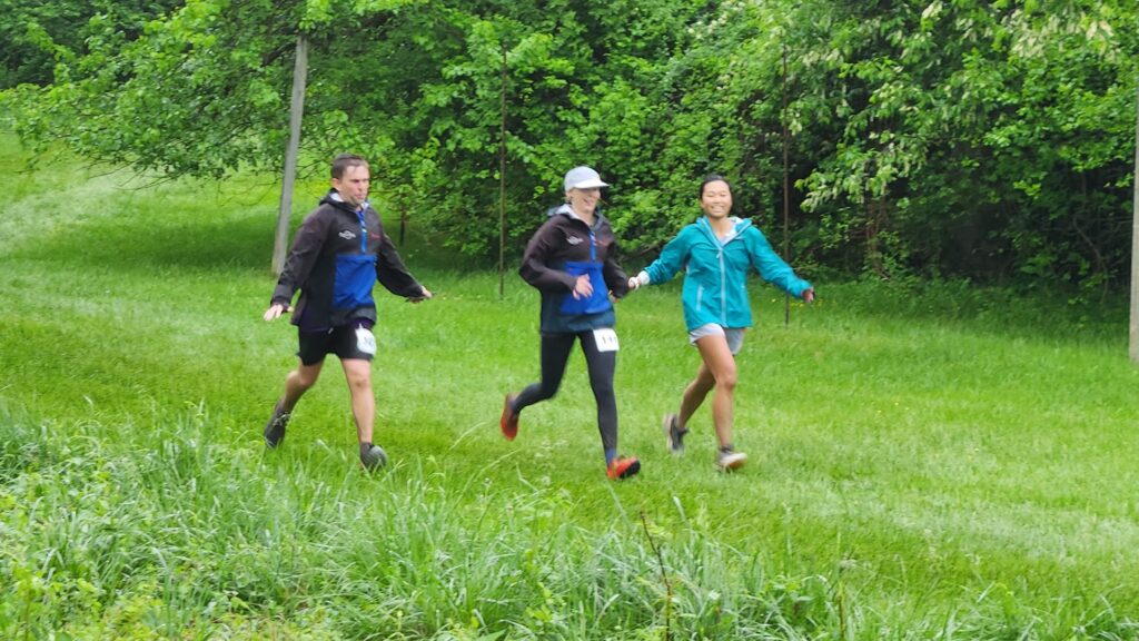 Three runners coming into the finish at Farm Park Challenge.